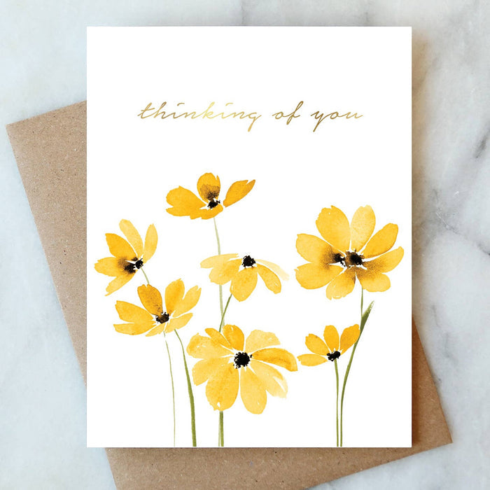 Thinking of You sympathy card with yellow daisy flowers and gold script text on white background
