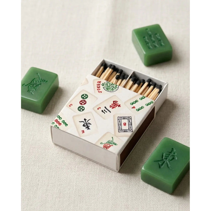 Mahjong-themed decorative matches with green jade tile boxes on neutral background