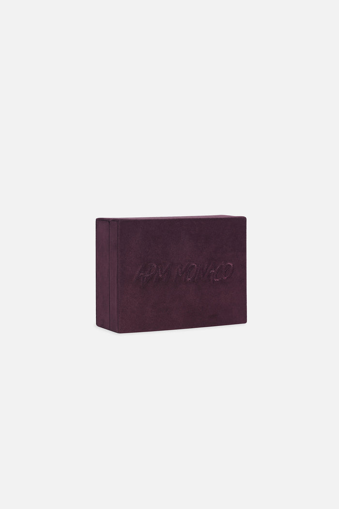 APM Monaco velvet jewelry box in deep burgundy, a signature touch of quiet luxury.