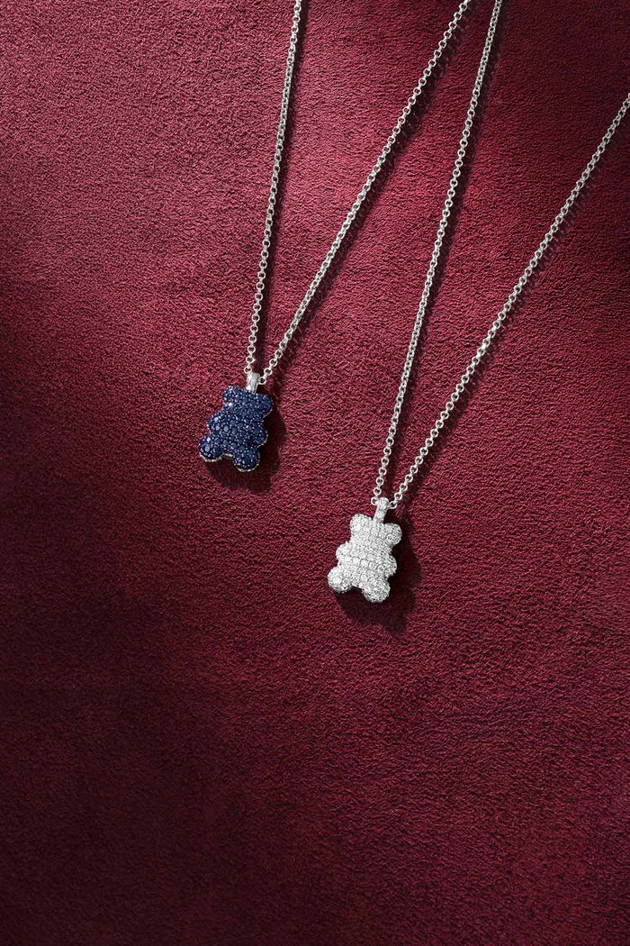 APM bear pendant necklaces, playful sparkle in blue and white, effortlessly charming.