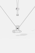 APM Necklace with a playful safety pin pendant, effortlessly cool in rhodium finish.