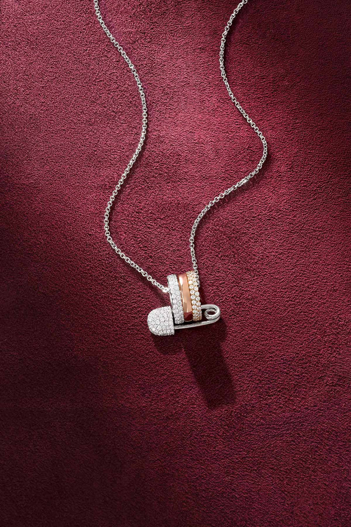 APM Safety Pin Necklace, a playful charm layered in tri-color brilliance.