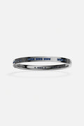 APM Bangle in rhodium finish with deep blue stones, bold and effortlessly modern.