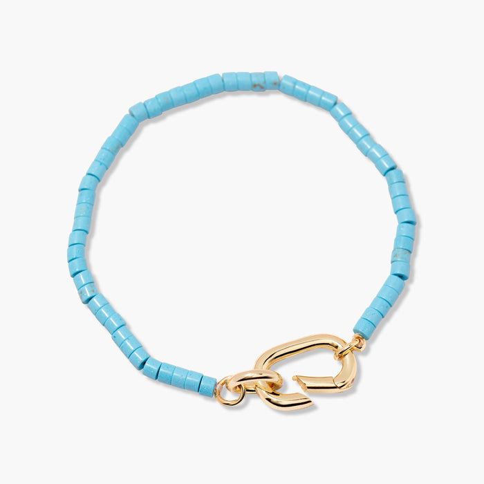 Light blue beaded bracelet with a gold clasp on a white background