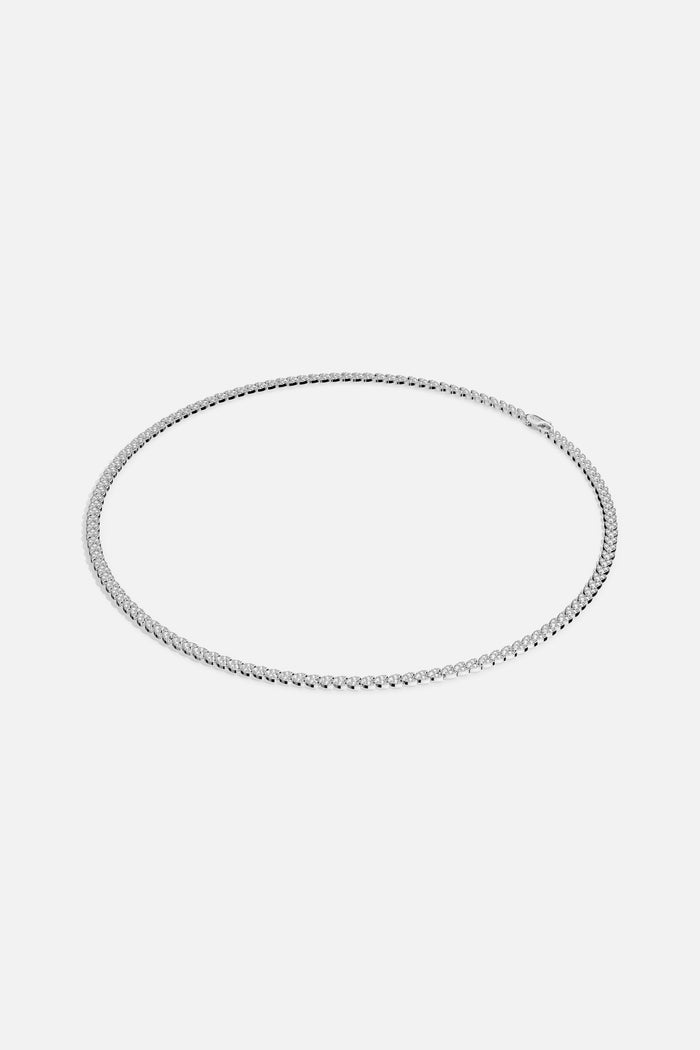 APM Tennis Necklace, a timeless line of light encircling every look with quiet brilliance.
