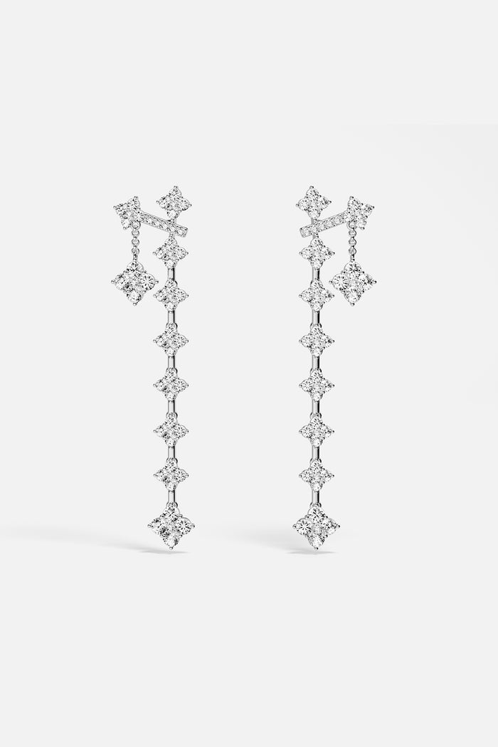 APM Drop Earrings cascading in luminous rhodium finish, effortlessly radiant.