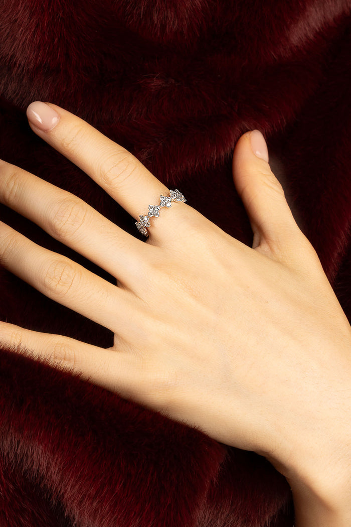 Woman wearing APM ring, a delicate sparkle against velvety crimson.