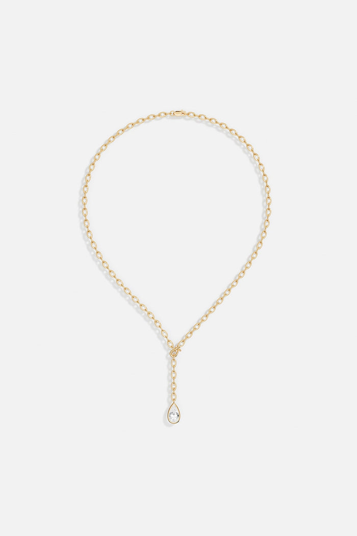 APM Necklace in golden color, a delicate teardrop falling with quiet elegance.