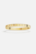 APM Monaco ribbed bangle in golden color, radiant modern elegance with a refined shimmer.