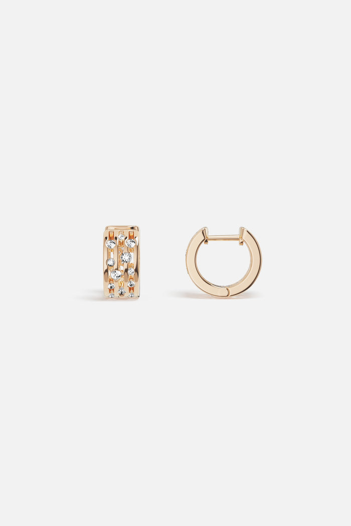 APM Hoop Earrings in warm gold color, sparkling with quiet confidence.