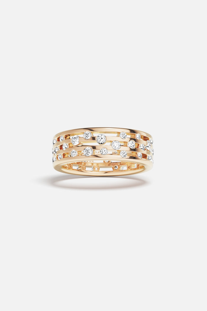 APM Ring in warm gold color, scattered stones dancing with quiet radiance.
