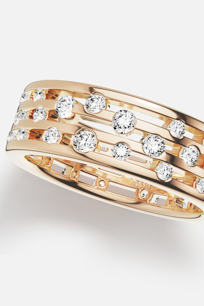 APM Ring in warm gold color, a scattering of stones shimmering with quiet radiance.