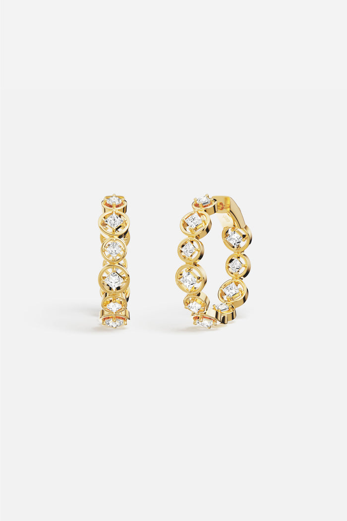 APM Hoop Earrings in golden color, a luminous rhythm of sparkle and light.