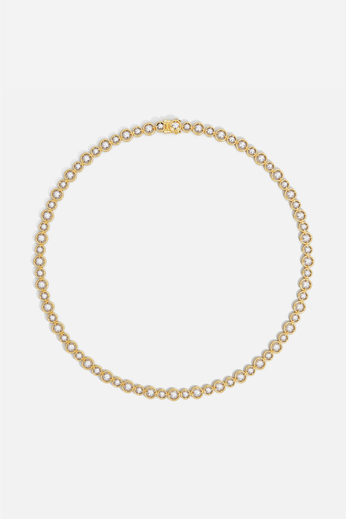 APM Necklace, a golden constellation of light circling the neck with quiet radiance.