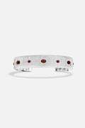 APM Cuff Bracelet, brushed rhodium finish scattered with deep red accents, quietly radiant.