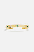 APM Monaco cuff bracelet in golden hues, scattered with emerald green stardust.