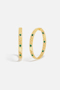 APM Hoop Earrings in golden hue, scattered with green stones, effortlessly radiant.