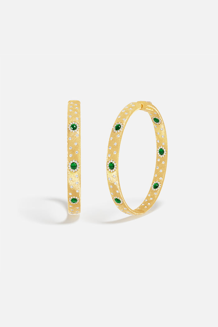 APM Hoop Earrings in golden hue, scattered with green stones, effortlessly radiant.