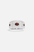 APM Monaco ring, brushed rhodium finish glowing with deep red accents, timeless allure.