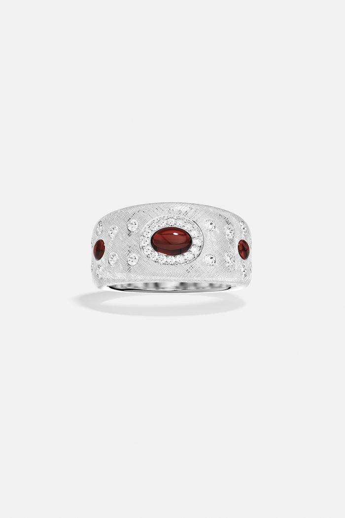 APM Monaco ring, brushed rhodium finish glowing with deep red accents, timeless allure.