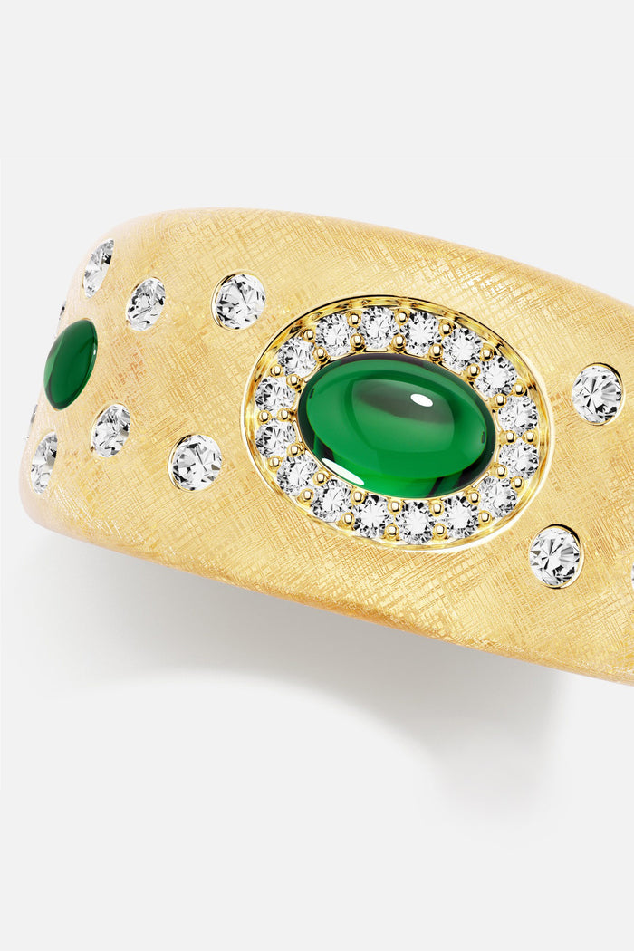 APM Ring in golden brushed finish, glowing with emerald green elegance.