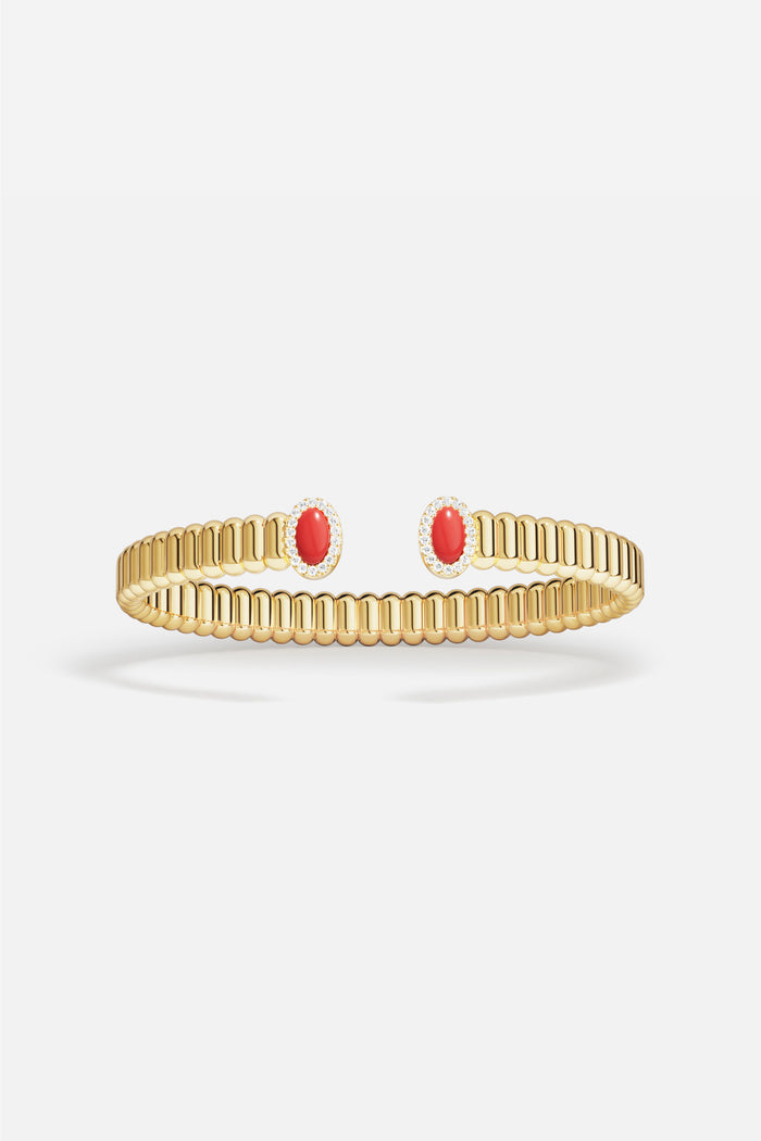 APM Bangle in golden color, ribbed elegance meeting bold red accents.
