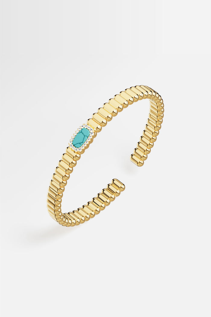 APM Bangle in golden hue, a turquoise whisper framed in quiet brilliance.