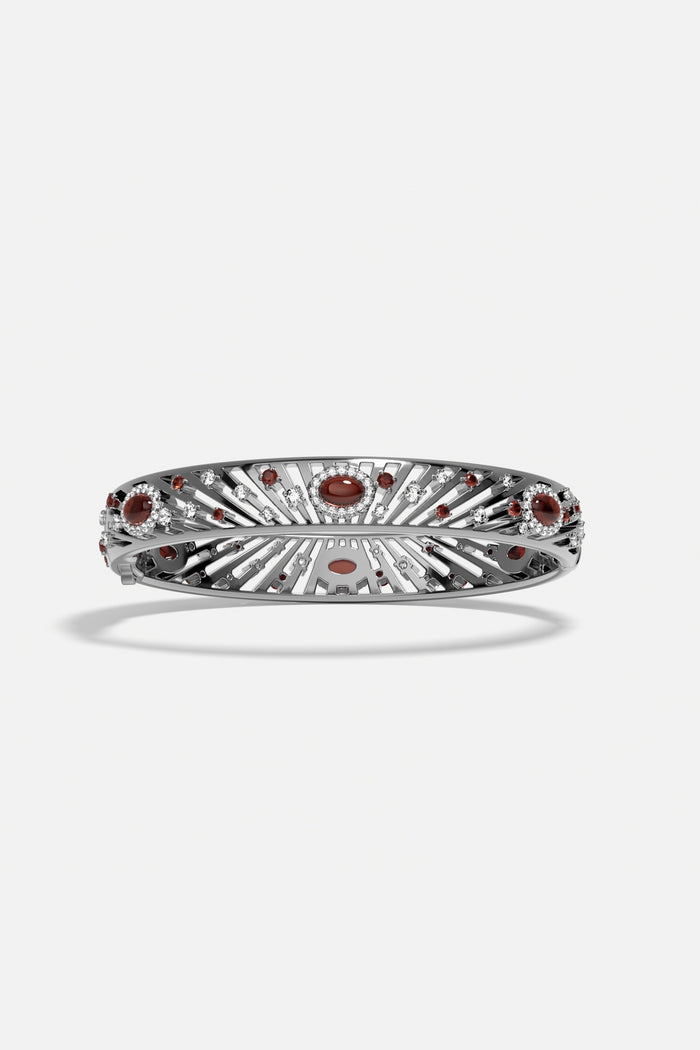 APM Bangle in rhodium finish with radiant red stones, a bold statement of elegance.