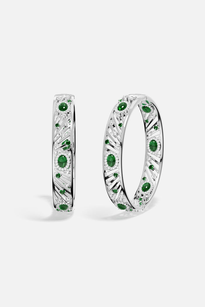 APM Bangles in rhodium finish with emerald green stones, radiant elegance with a modern edge.