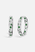 APM Bangles in rhodium finish with emerald green stones, radiant elegance with a modern edge.