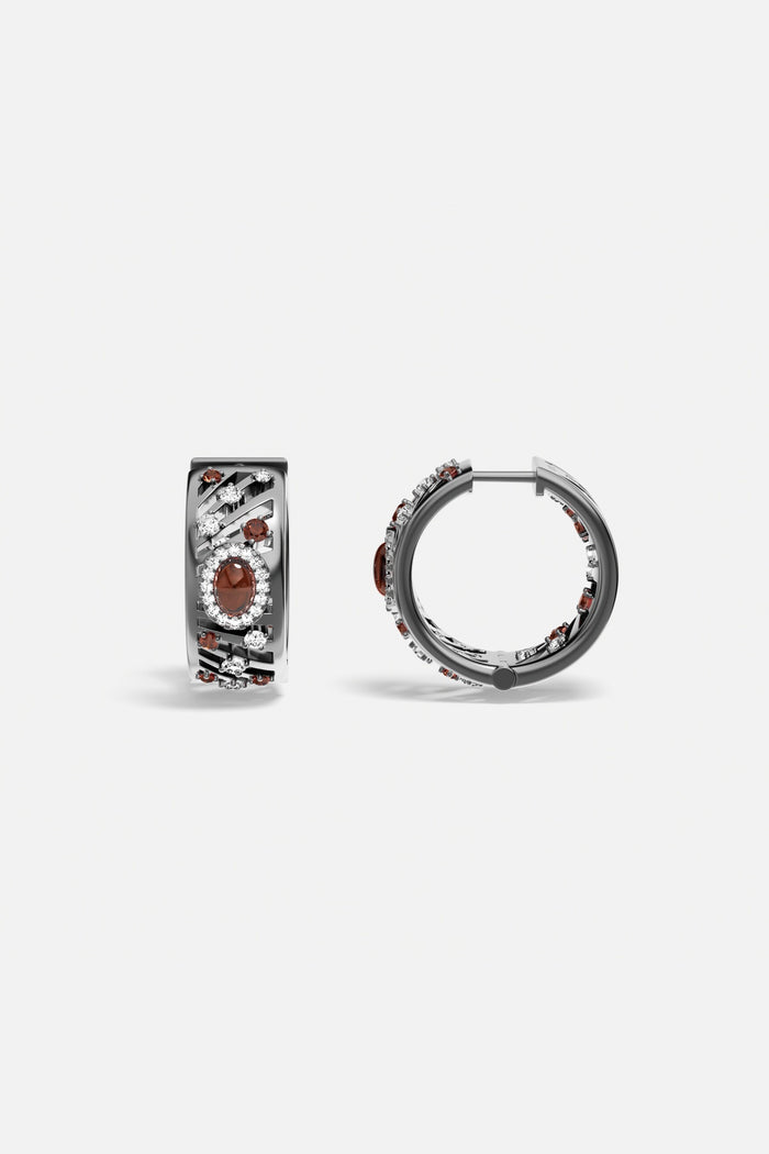 APM Hoop Earrings in rhodium finish, glowing with deep red and crystal accents.
