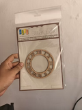 4 inch MDF laser-cut Roman numeral clock frame in packaging, held in hand — wood veneer craft piece for card making and resin art