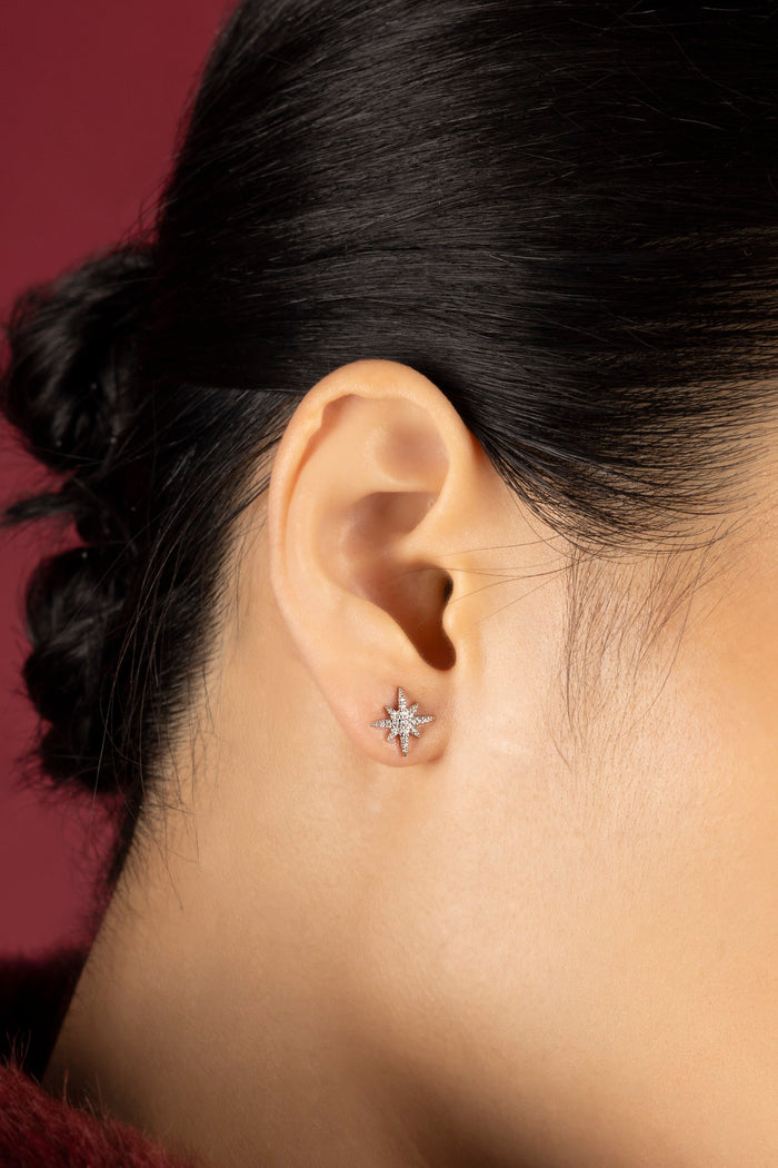 Woman wearing APM star stud earrings, a quiet sparkle of celestial charm.