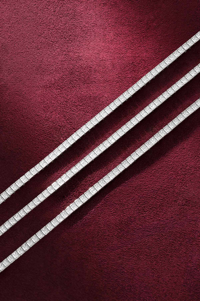 APM tennis bracelets in rhodium finish, aligned with quiet radiance on velvet.