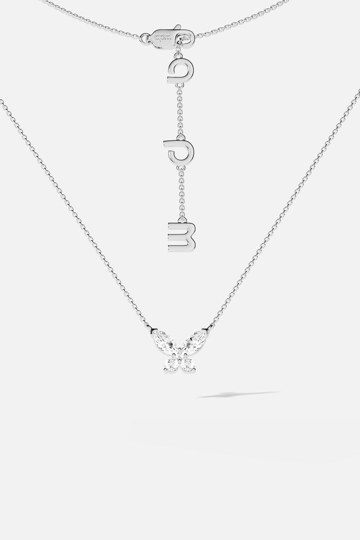APM Butterfly Necklace, a delicate flutter in rhodium finish, effortlessly luminous.