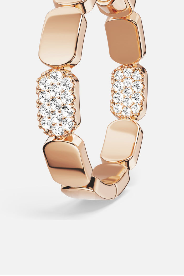 APM Ring in warm rose color, sculpted links meeting a shimmer of pavé brilliance.
