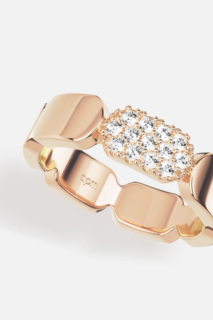 APM Ring in warm rose color, sculpted links meeting a delicate shimmer of stones.