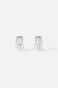 APM Earrings, triple arcs of shimmer in a rhodium finish, quietly radiant.