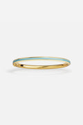 APM Bangle in gold tone with turquoise enamel, a breezy touch of Riviera charm.