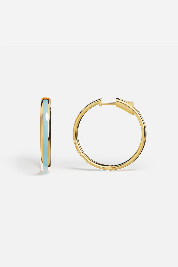 APM Hoop Earrings in golden hue with a soft blue whisper, effortlessly chic.