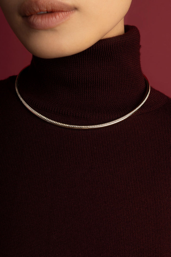 Woman wearing APM Monaco choker necklace, a sleek line of quiet elegance.