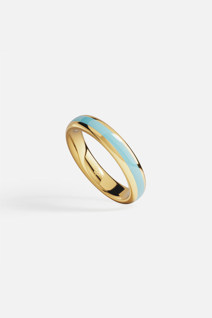 APM Ring in golden color with soft blue enamel, effortlessly chic.