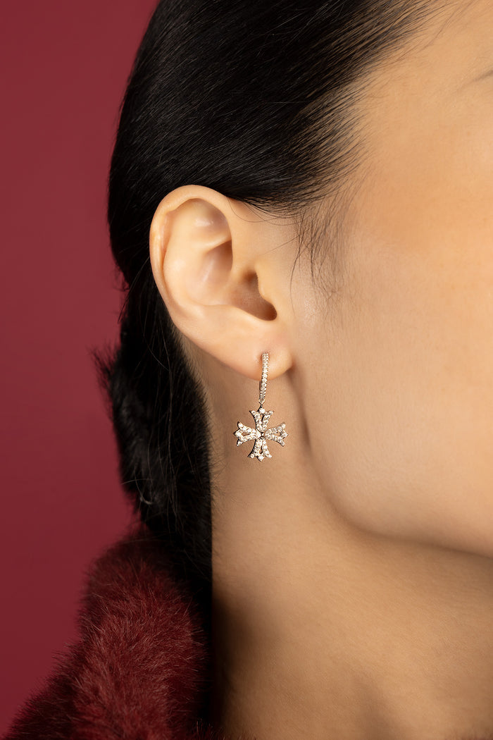 Woman wearing APM earrings, a delicate sparkle framing quiet elegance.