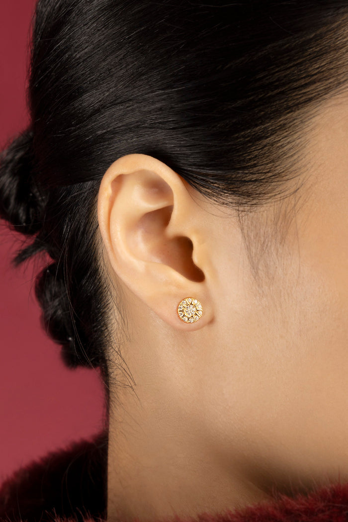 Woman wearing APM Morse Earrings, a radiant whisper of golden elegance.