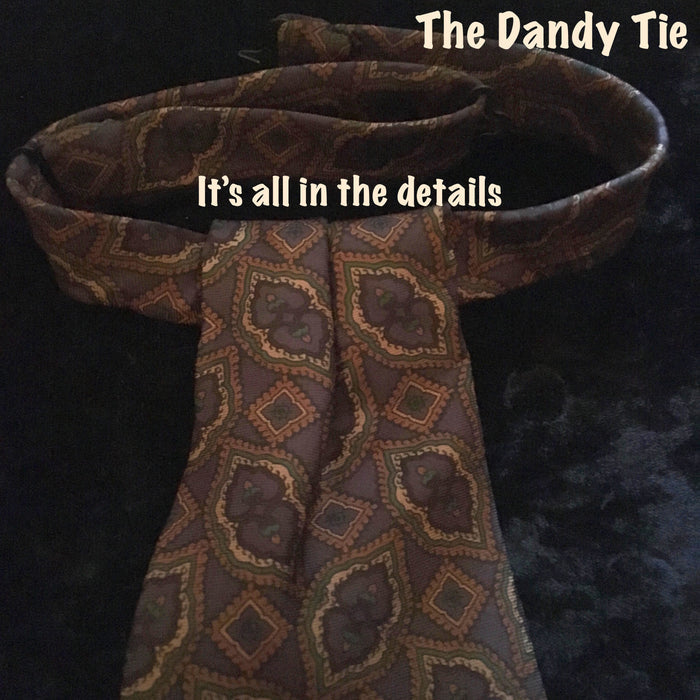 The Dandy Tie.  Each is a ONE OF A KIND and HANDMADE,by me, out of recycled neckties I handpick because of their texture or color or print. Created for men AND women, and designed to be worn for a lifetime, because of their timeless elegance, you are guaranteed to never see another like yours. Completely adjustable, the Dandy Tie is meant to be worn with or without a shirt. Use your own imagination!