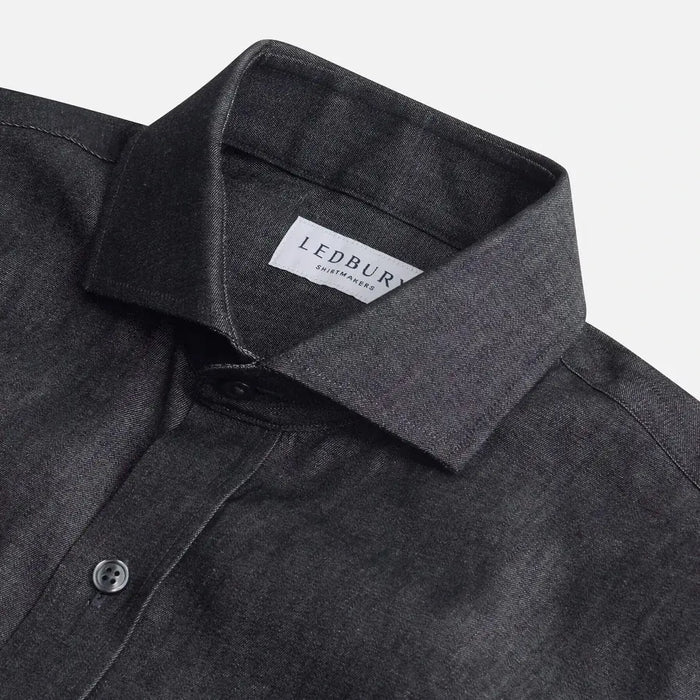 Washed black denim shirt collar detail - broken-in cotton construction