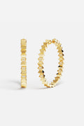 APM Hoop Earrings in gold color, bold edges meeting quiet sparkle.