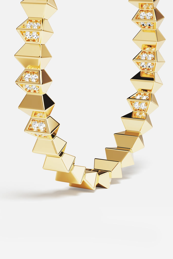 APM Necklace in golden color, bold geometric edges glowing with quiet confidence.