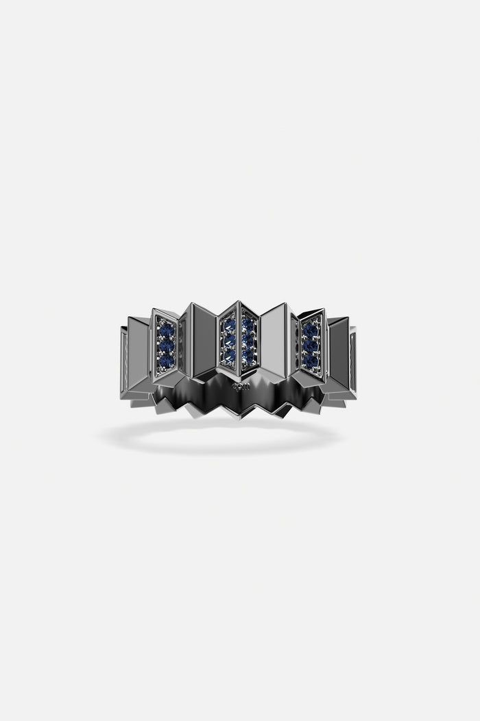 APM Ring, sculpted architecture with deep blue accents, boldly modern.