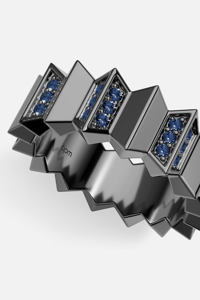 APM Ring in black rhodium finish, sculpted geometry with deep blue stones, boldly modern.